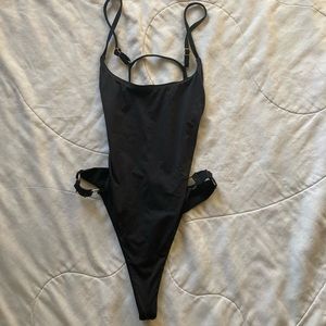 Size medium black slip on bathing suit metal rings on sides backless never worn